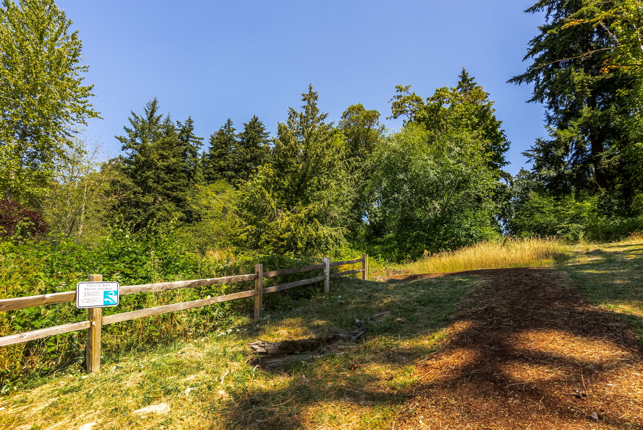 A wooden fence in a field.