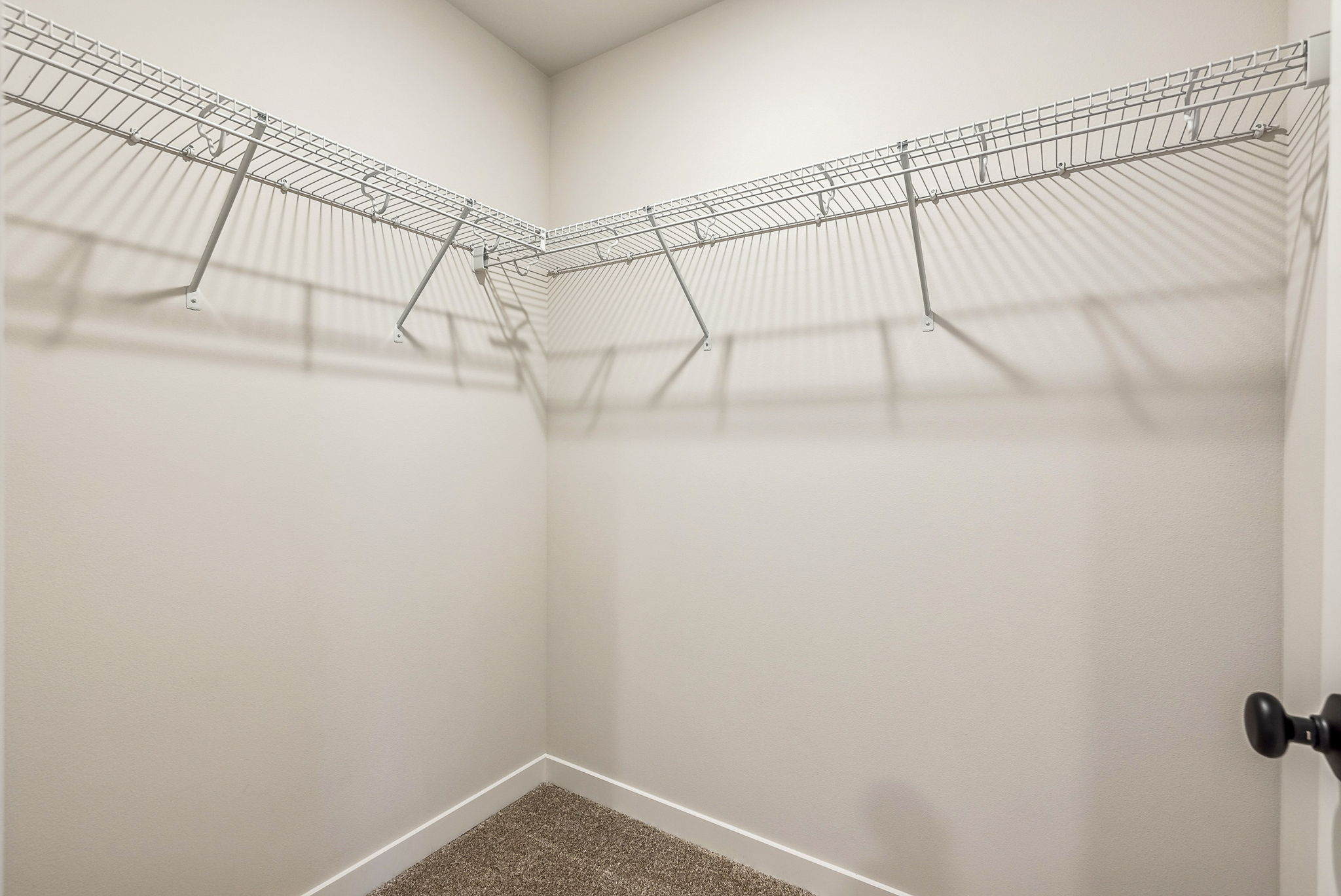 A white wall with a metal railing.