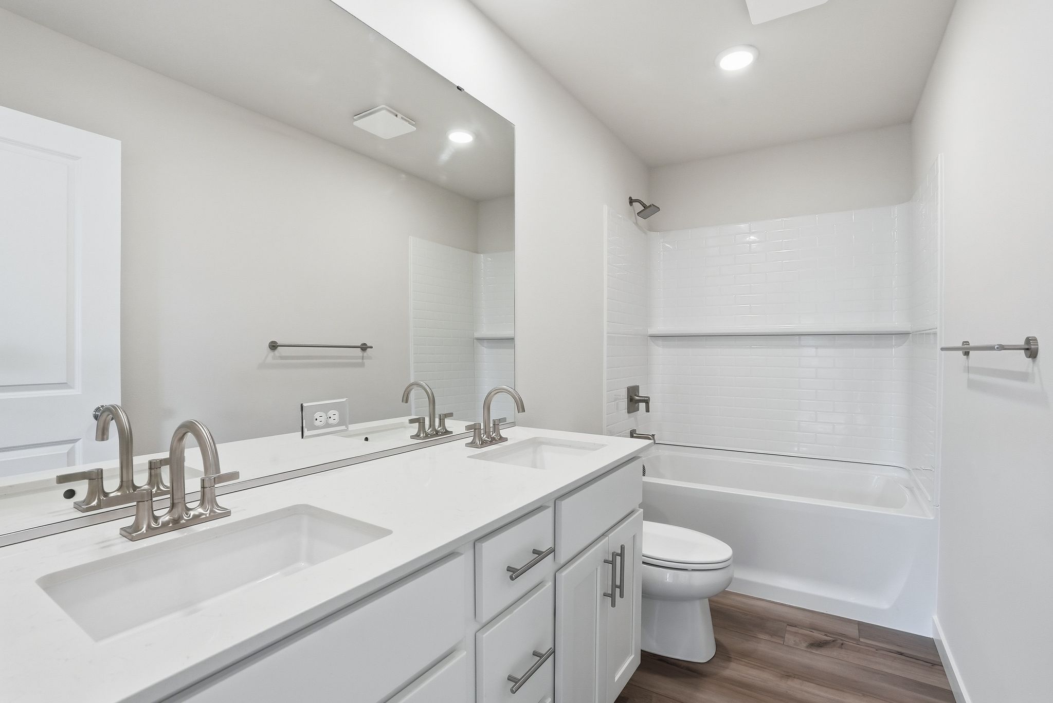 A bathroom with a tub sink and toilet.