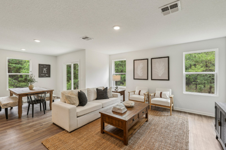 A living room with a white couch and a table.