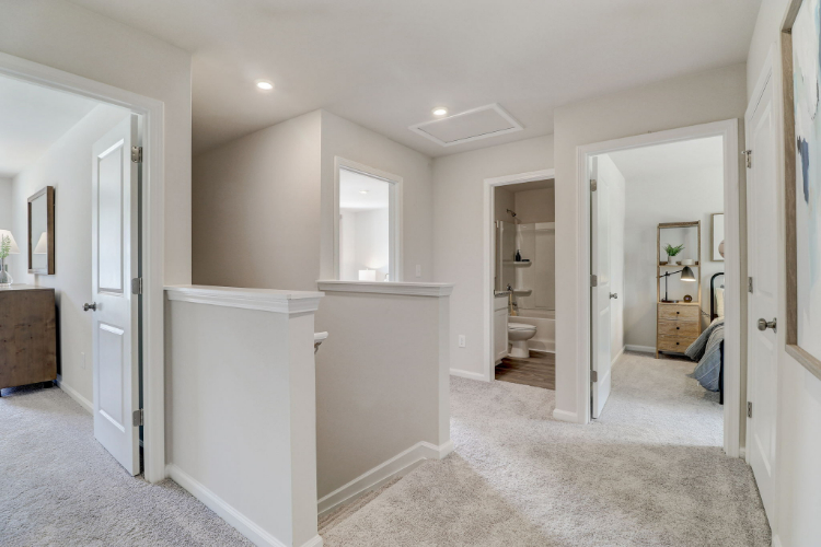 A bathroom with white cabinets.