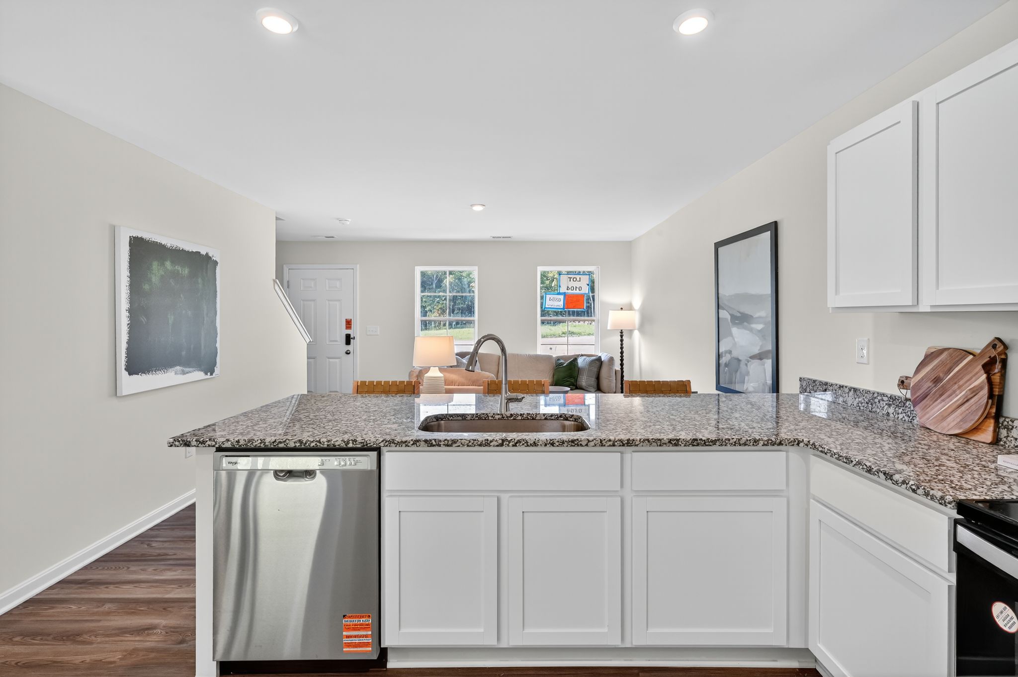 A kitchen with white cabinets.