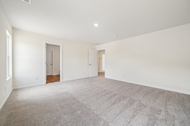 A long hallway with white doors.