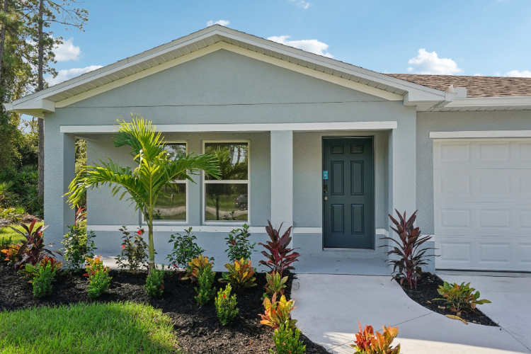 A house with a garage and trees.