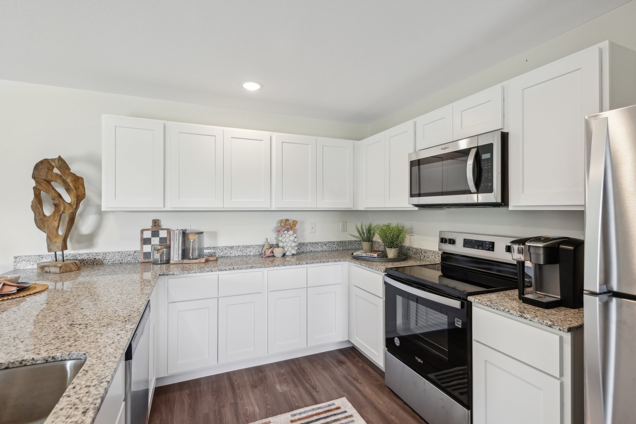 A kitchen with white cabinets.