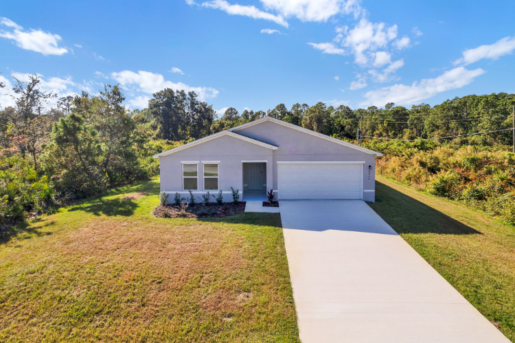A house with a driveway and grass.