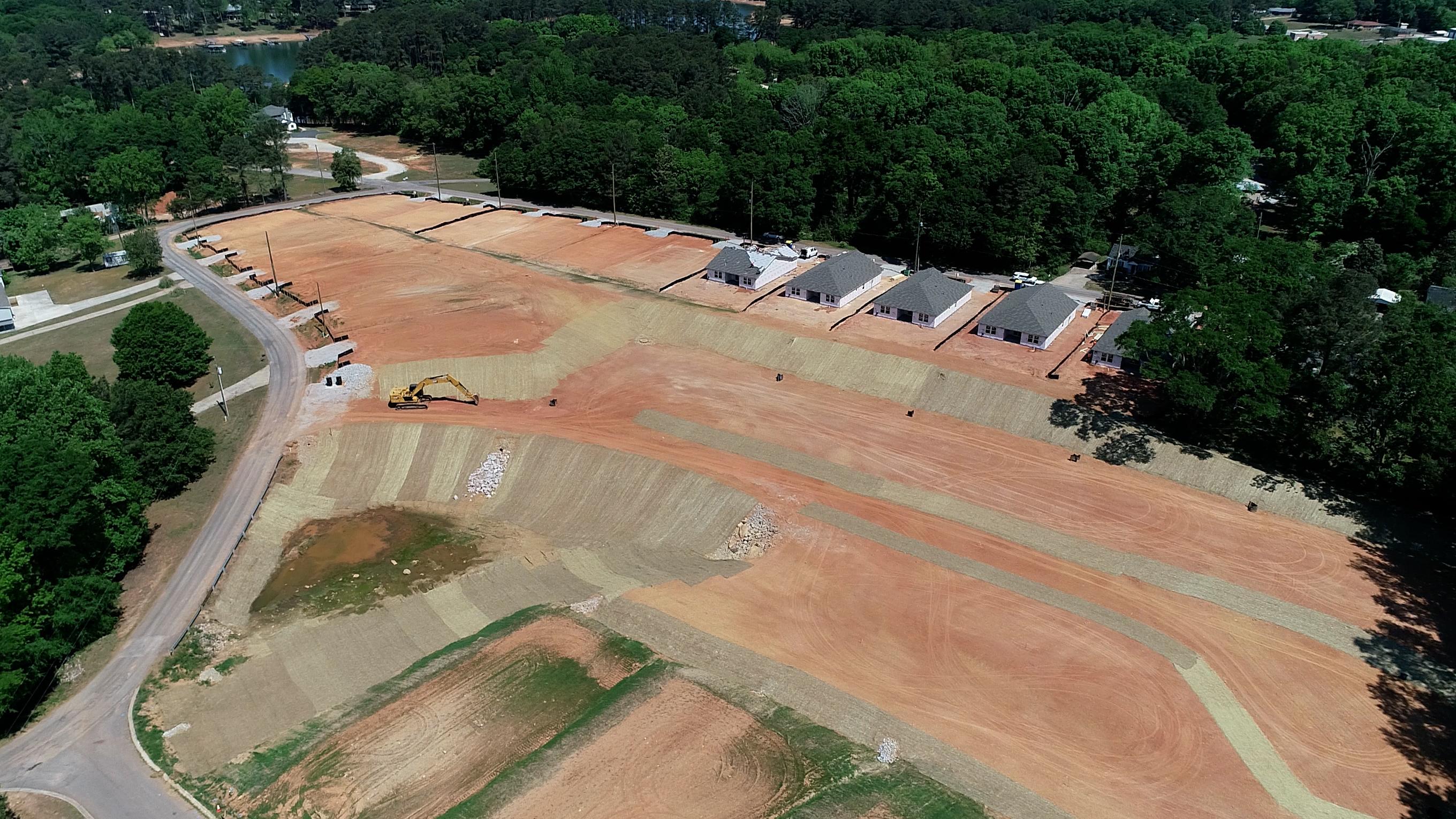 A large field with a few buildings.