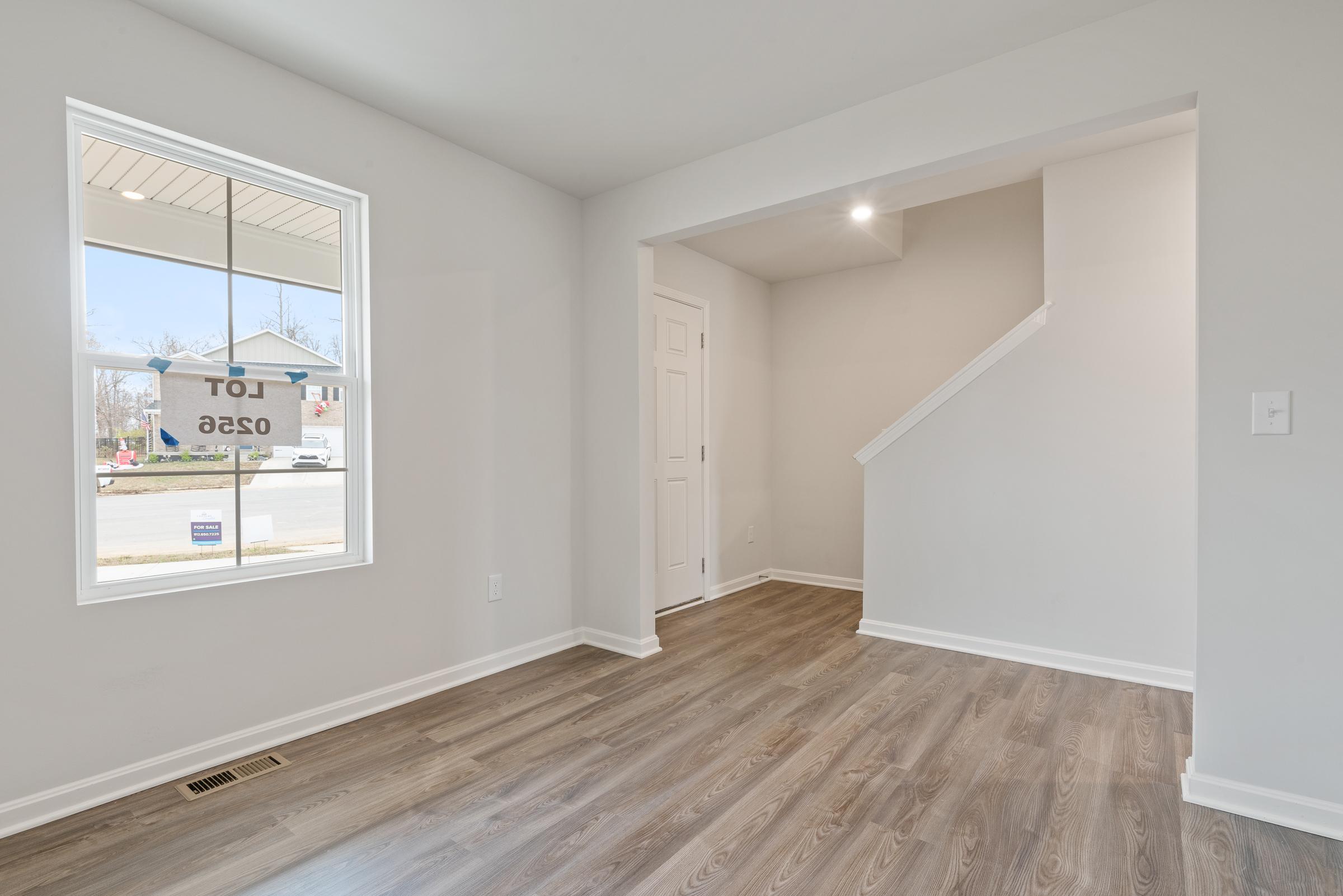 A room with a wood floor and a window.