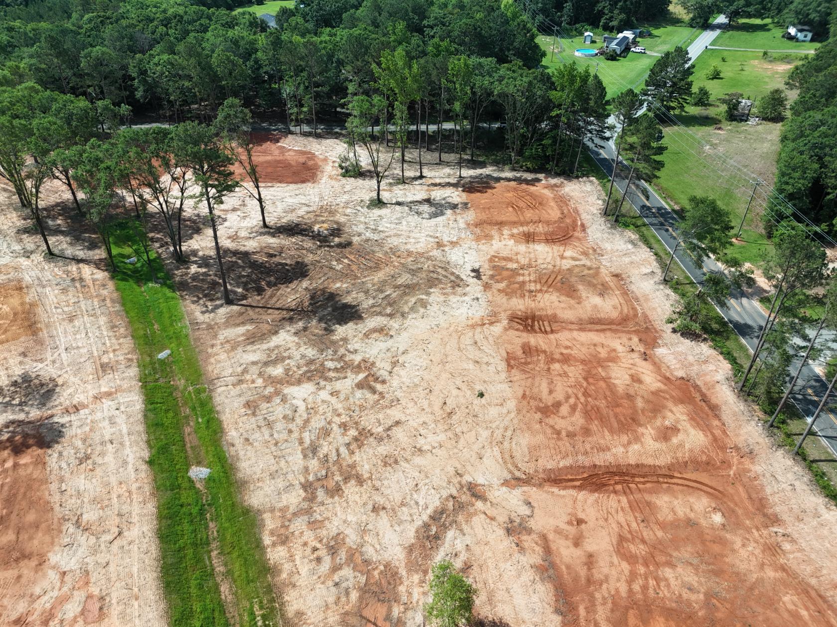 A dirt road with trees on the side.