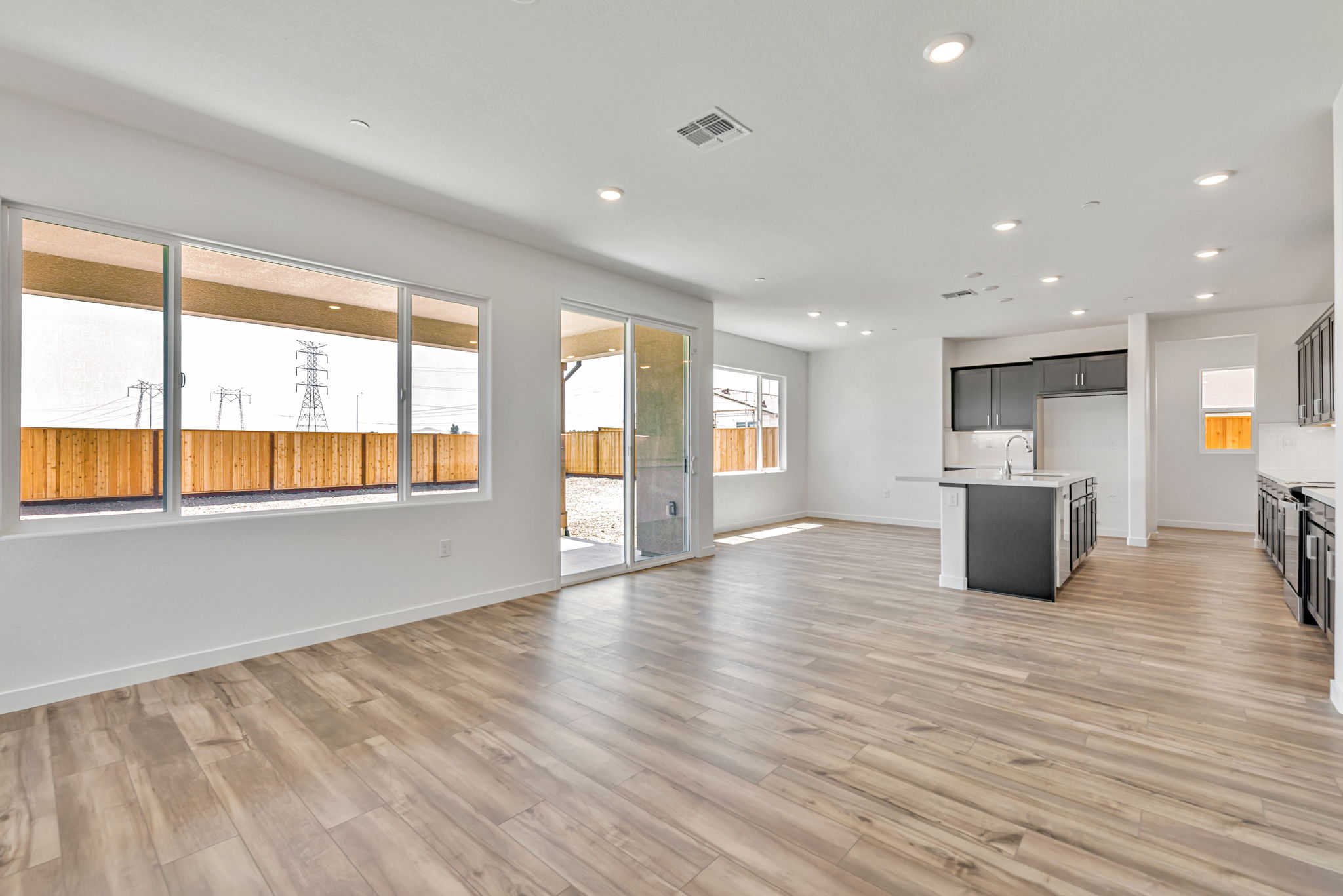 A large empty room with a wood floor and a large window.