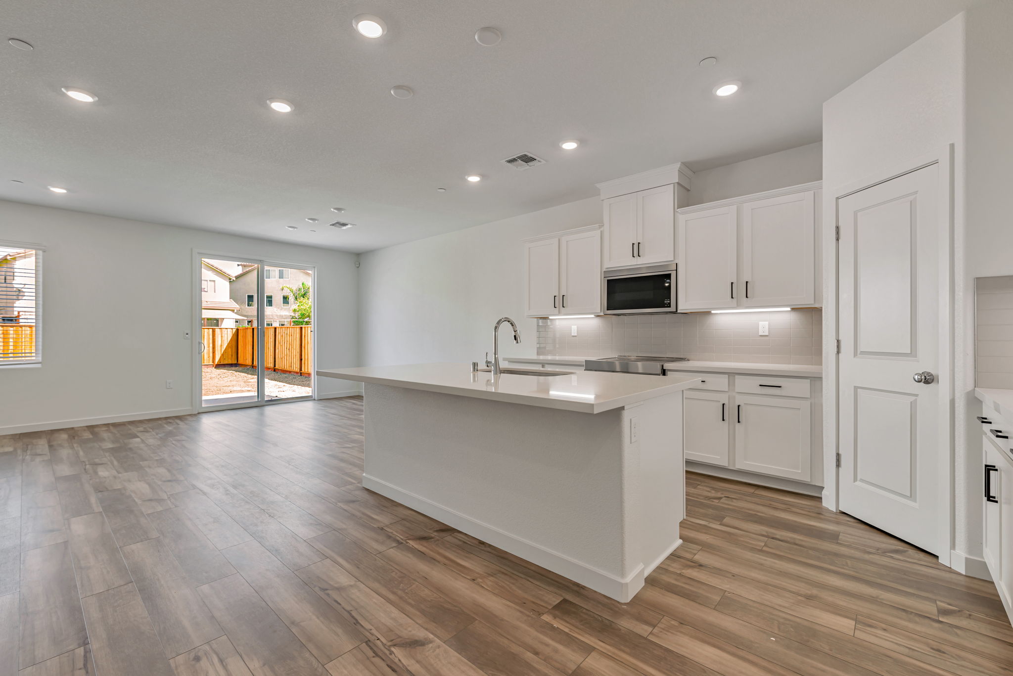 A kitchen with white cabinets.