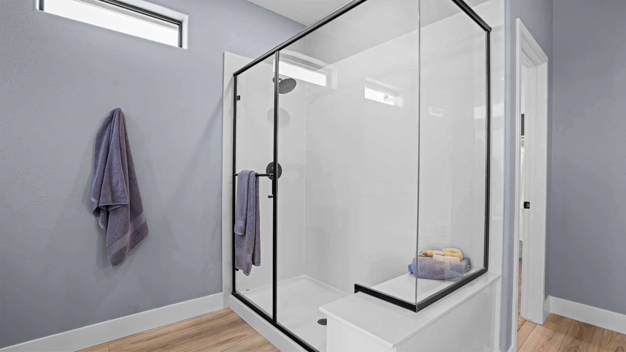 A shower with a glass door.